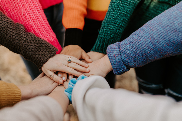 Group with hands put togther in the middle